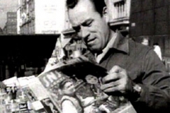 Kuva: Heimo Lepist�n esitt�m� haalaripukuinen ty�mies lukee SNS-lehte�. (1953) YLE kuvanauha.