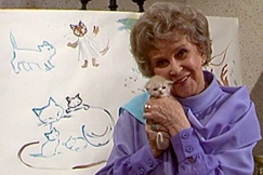 Kuva: Kylli-t�ti pit�� kissanpentua syliss��n. YLE kuvanauha. 